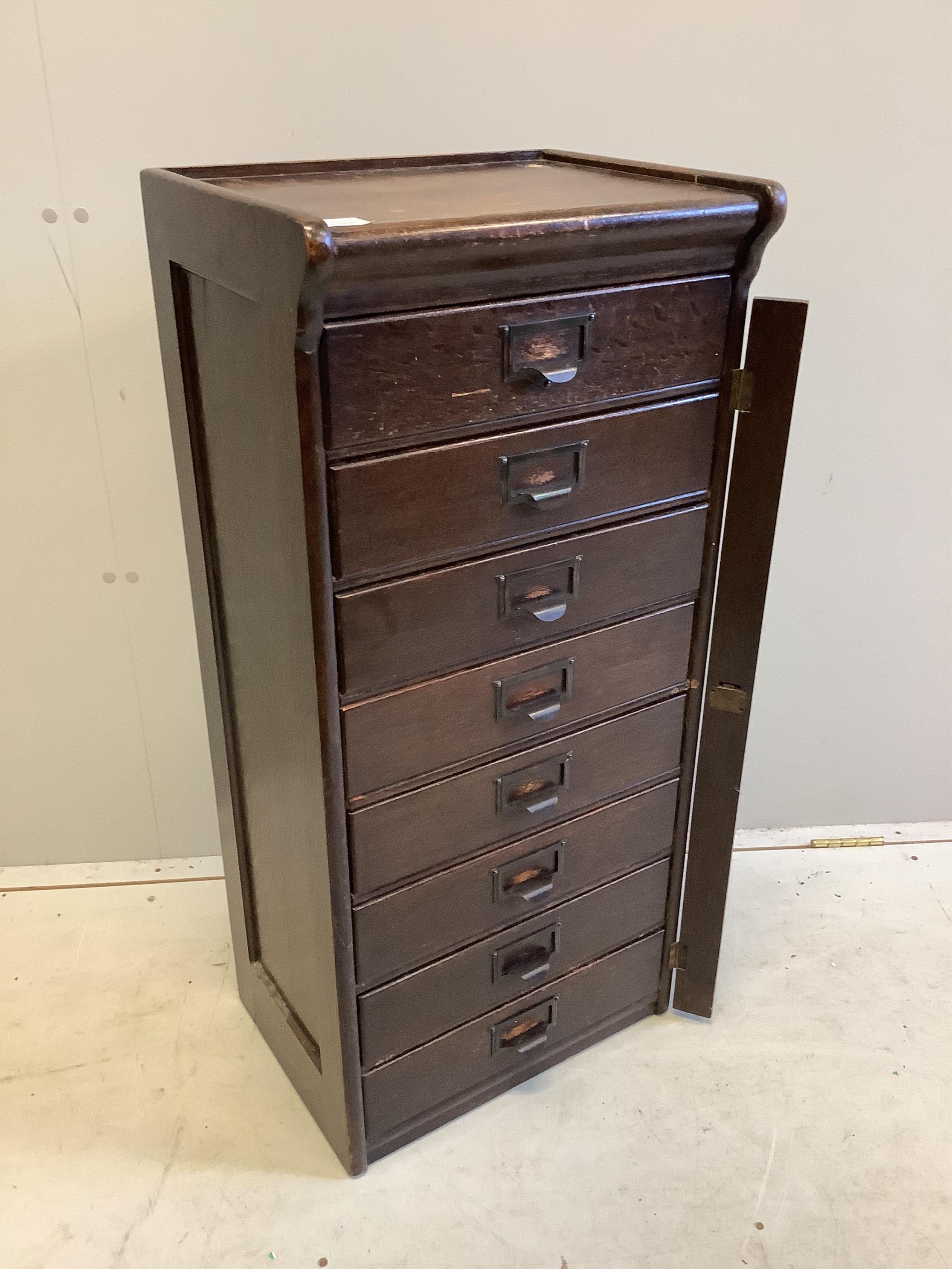 A Globe Wernicke oak eight drawer filing cabinet, width 44cm, depth 34cm, height 97cm. Condition - fair